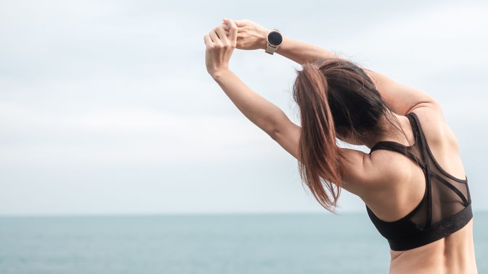 海辺で準備体操をしている女性