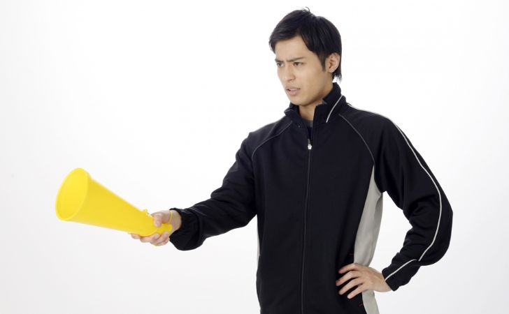 メガホンを持って厳しく指導する教師